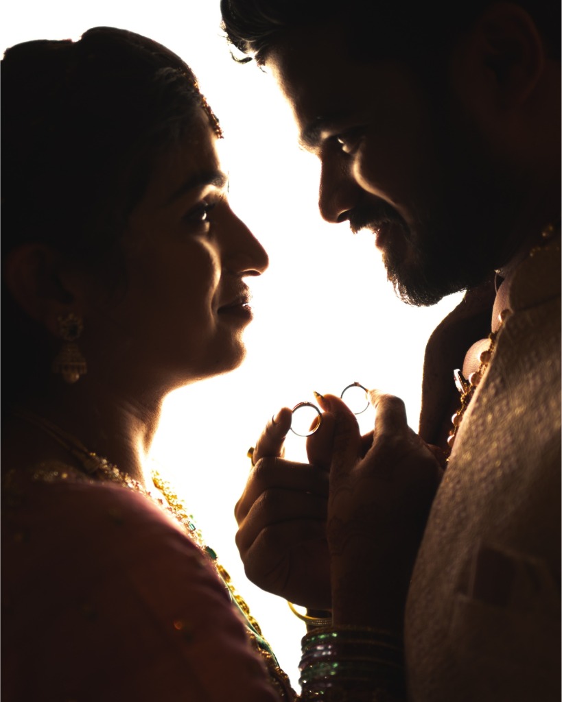 Romantic silhouette holding wedding rings - pre-wedding photography